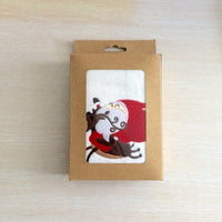 Charming cotton towel with an embroidered design of Santa and a reindeer, perfect for Christmas celebrations.