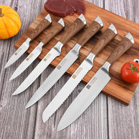 A set of lightweight knives on a cutting board with some food