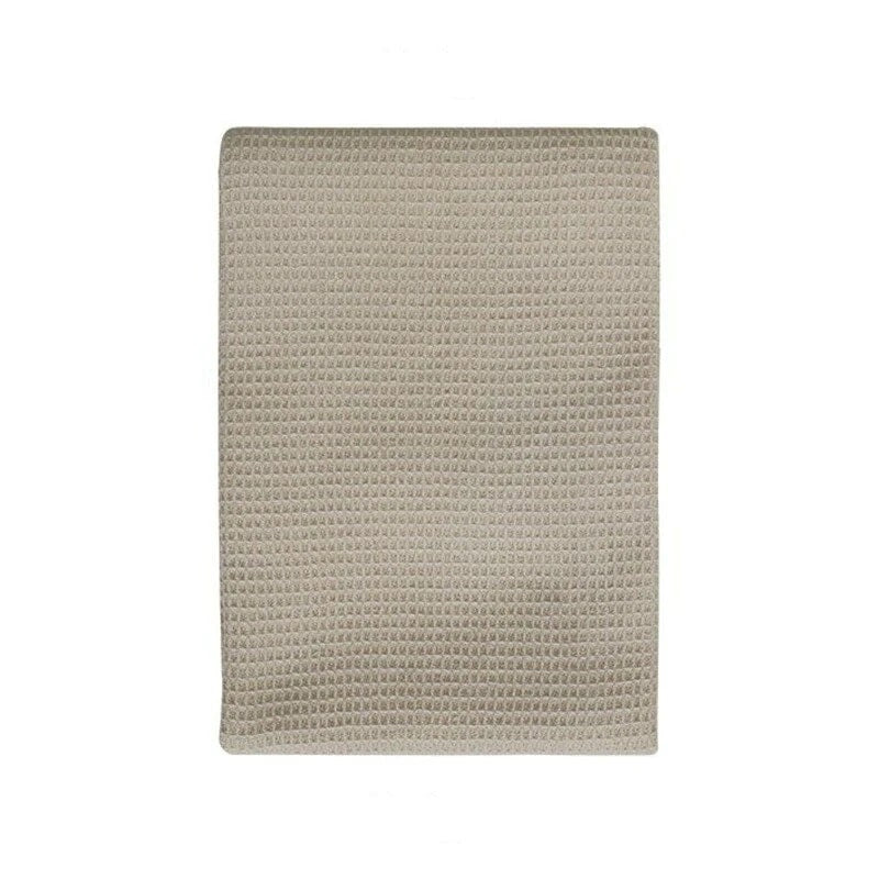 This beige tea towel is crafted from thick and absorbent waffle fabric.