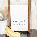 A white cotton kitchen towel, sized 27 x 27 inches, featuring text suitable for a family with boys.