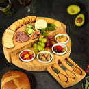 Bamboo cheese board with crackers, cheese, fruit, and other snacks ready to enjoy