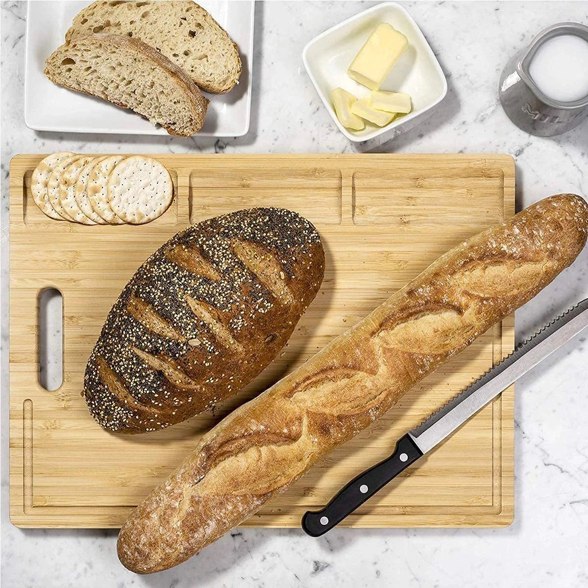 Bamboo chopping board with bread and knife on top it