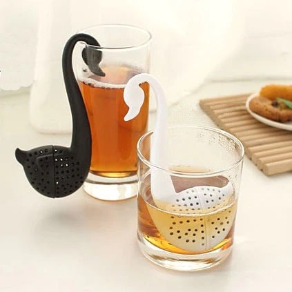 White and black wan shaped tea infusers in glass teacups