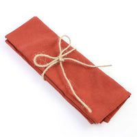 Brick red cotton napkins bring color to your meal table.