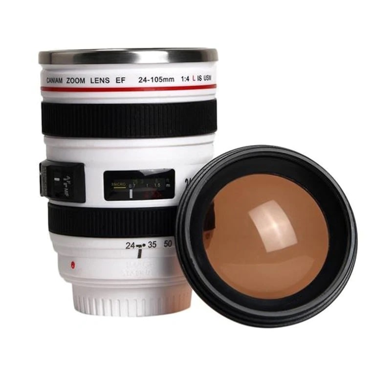 A white camera lens travel cup for hot drinks