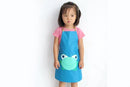 A little girl wearing a blue pinny