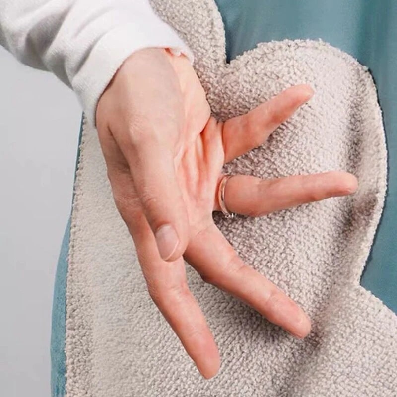 A woman drying hand to the side of her apron