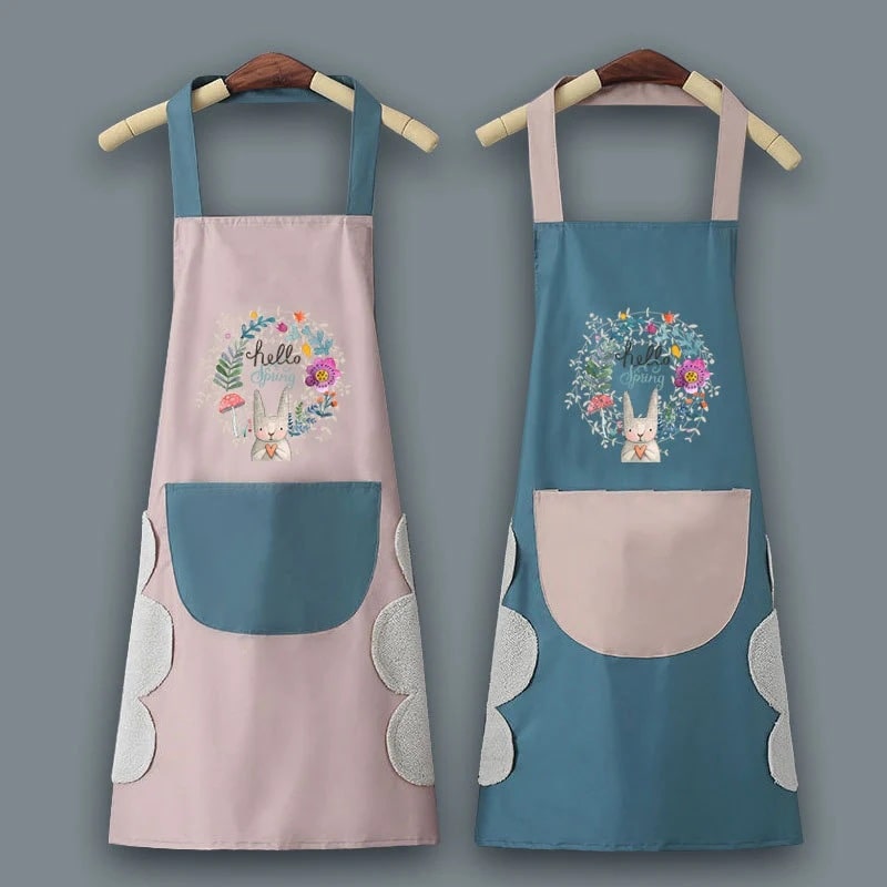 Two cute aprons hanging on hangers