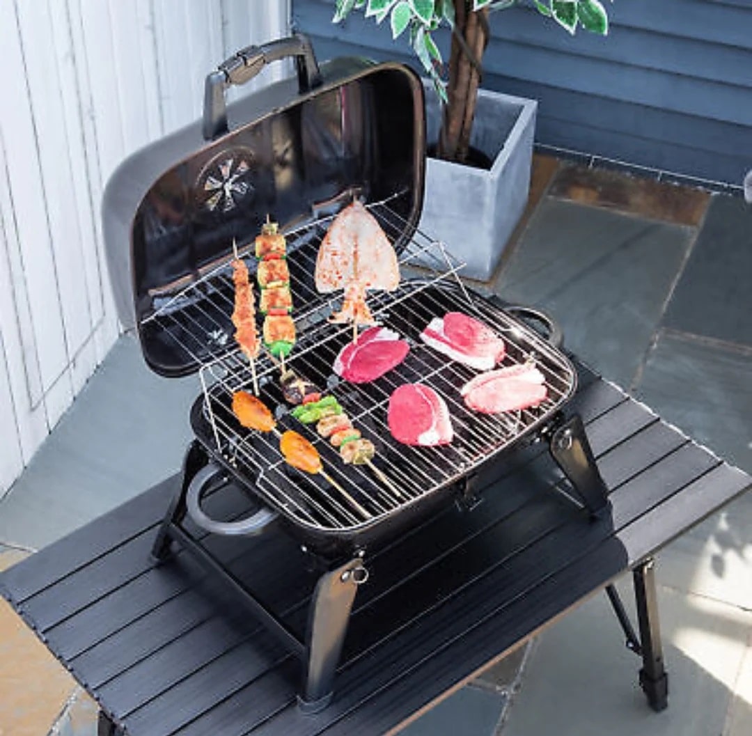 Portable charcoal grill with folding legs