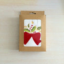 Embroidered cotton towel with a festive bow and mistletoe design, perfect for holiday decor.