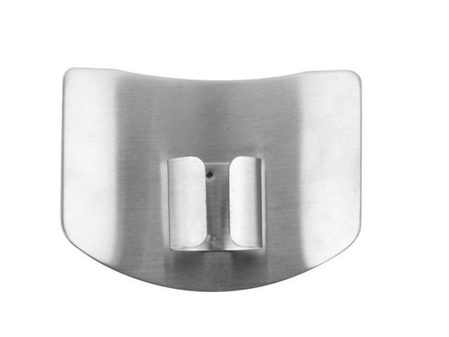 The backside of a stainless steel finger protector for cutting vegetables and other food items safely