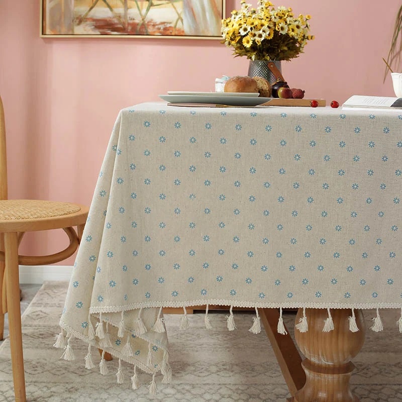 This delicate cotton tablecloth ads a touch of elegance to any setting.