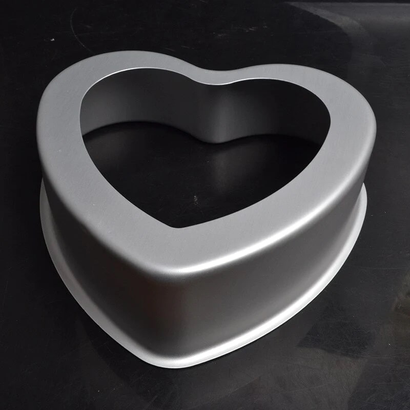 A heart-shaped cake pan with a removable bottom