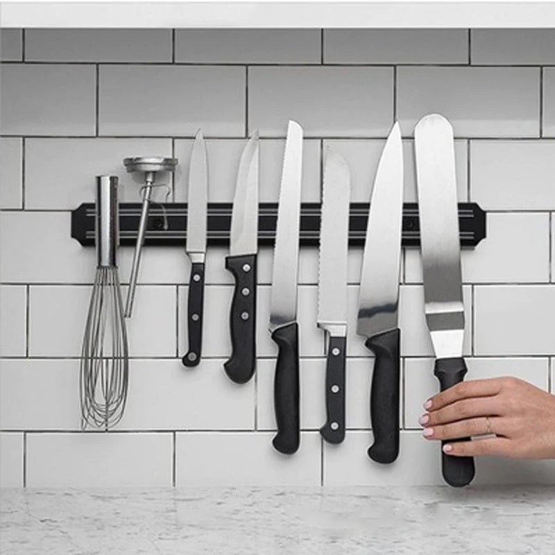 A person using super handy wall-mount knife strip