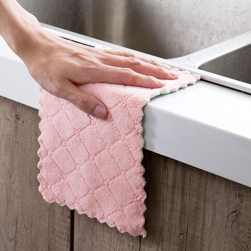 A soft kitchen towel wiping around the sink