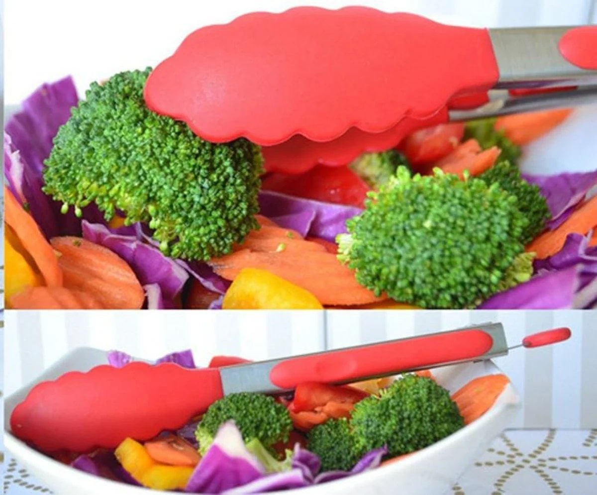 Silicone tongs serving a bowl of fresh vegetables.