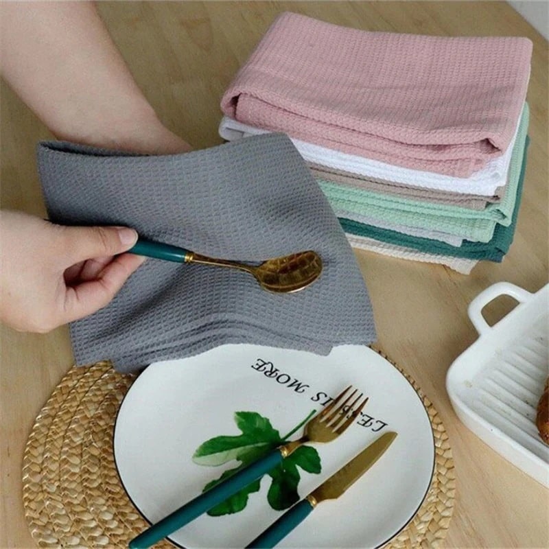 Beautiful kitchen towels drying cutlery