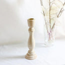 A beautifully carved wooden candlestick from unfinished wood